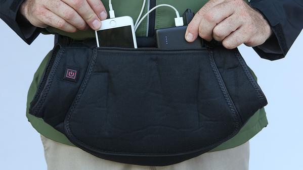 Black battery powered handmuff showing battery and phone charging