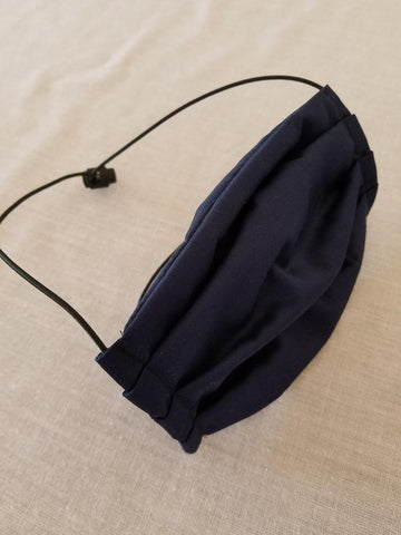 Hand sewn Fabric Face Masks. Extra long drawstring fits and locks behind head. Eliminates pressure on ears. Washable and reusable Made in USA, Black or Navy